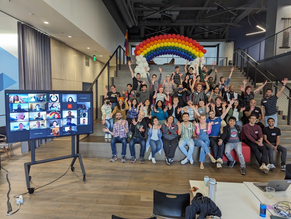 Diverse, excited and warm group of volunteers smiling and posing after the digital corp hackathon.